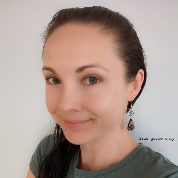 Woman wearing Alya Dangles as a size guide