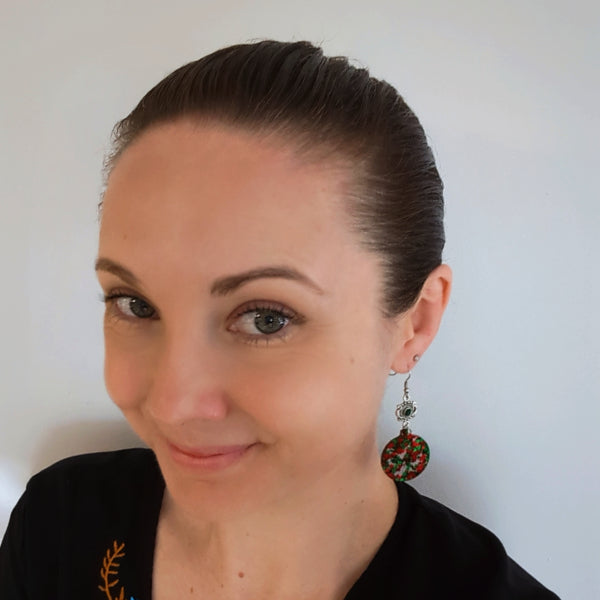 Woman wearing Joy Dangles as a size guide.