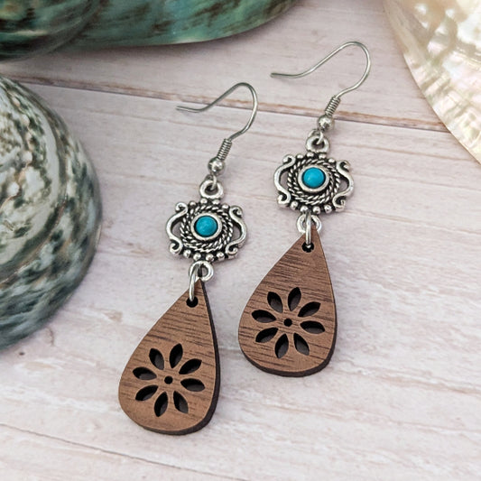 Wooden teardrop earrings with silver and turquoise accents on a light wooden surface. Stainless steel hooks.
