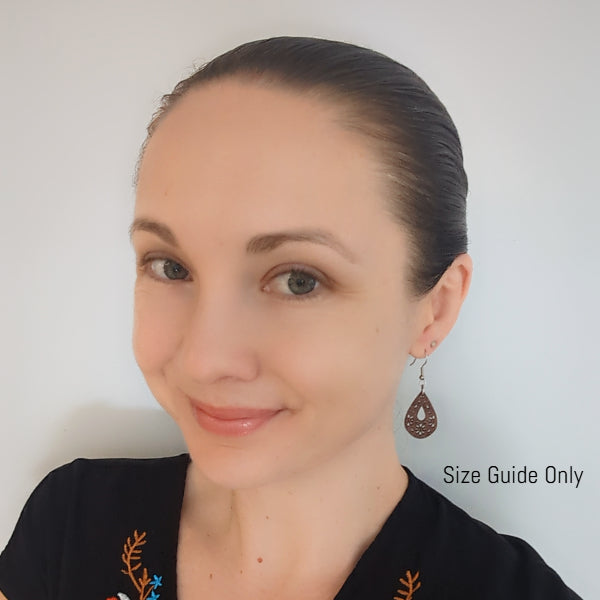 Women wearing wooden earrings for a guide on size of the earring design.