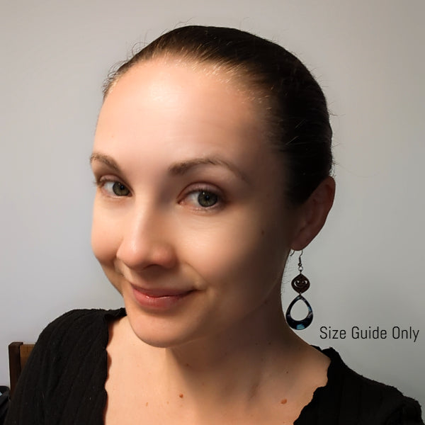 Woman wearing April dangles as a size guide.