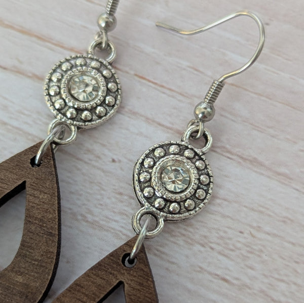 Close up of silver toned crystal connectors. Stainless steel hooks.