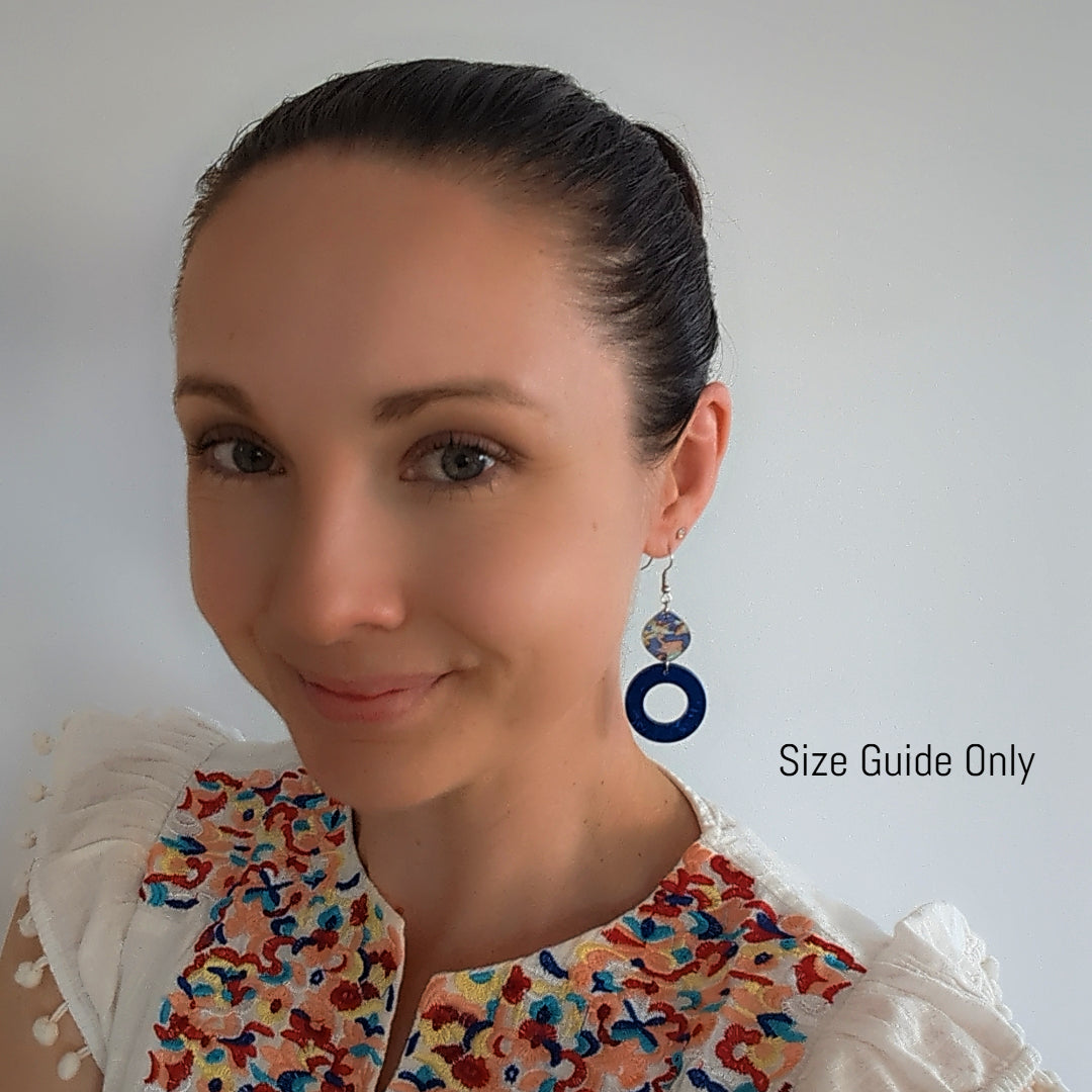 Woman wearing Celeste Dangles as a size guide. 
