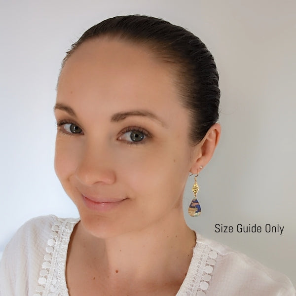 Woman wearing Edan Dangles as a size guide.