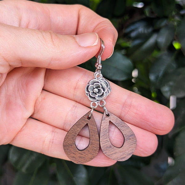wooden tear drop earrings with silver toned flower connectors. Stainless steel hooks.