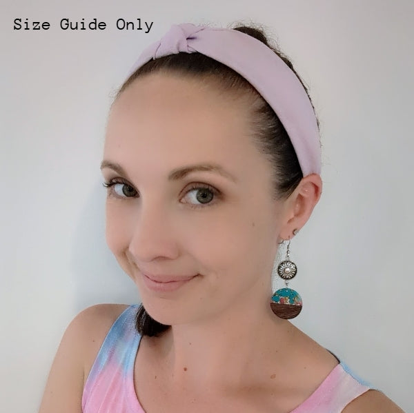 Women wearing coloured Starburst Dangles as a size guide.