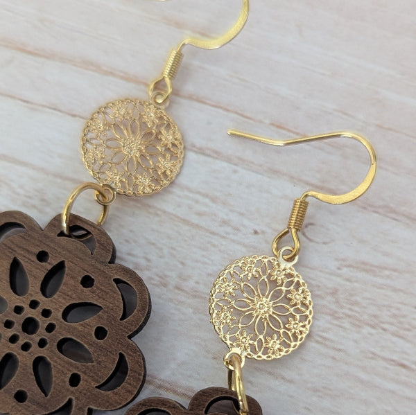 Gold and wooden earrings on a light wood surface. Gold plated stainless steel hooks.