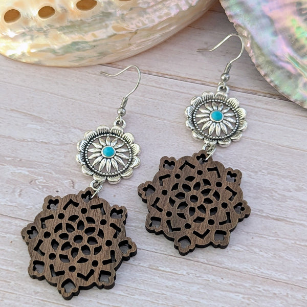 Wooden earrings with silver and turquoise accents on a light wooden surface. Stainless steel hooks.