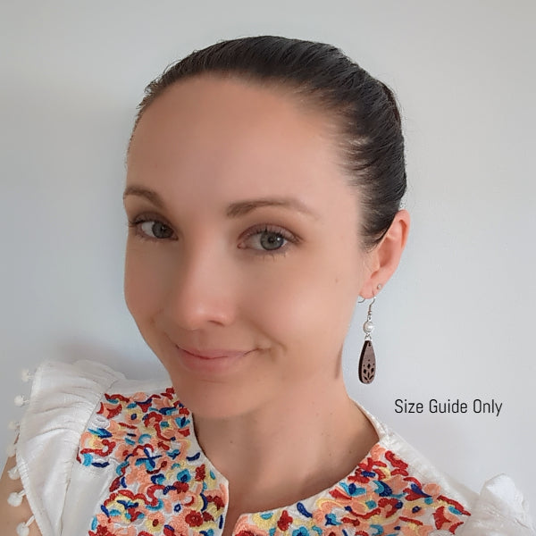 Woman wearing Lana Dangles as a size guide.