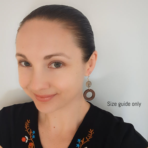 Women wearing wooden earrings for a guide on size of the earring design.