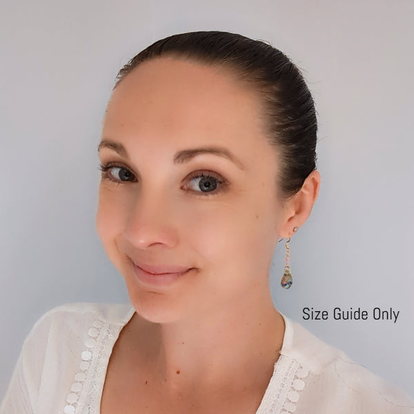 Woman wearing Pixie Dangles as a size guide.