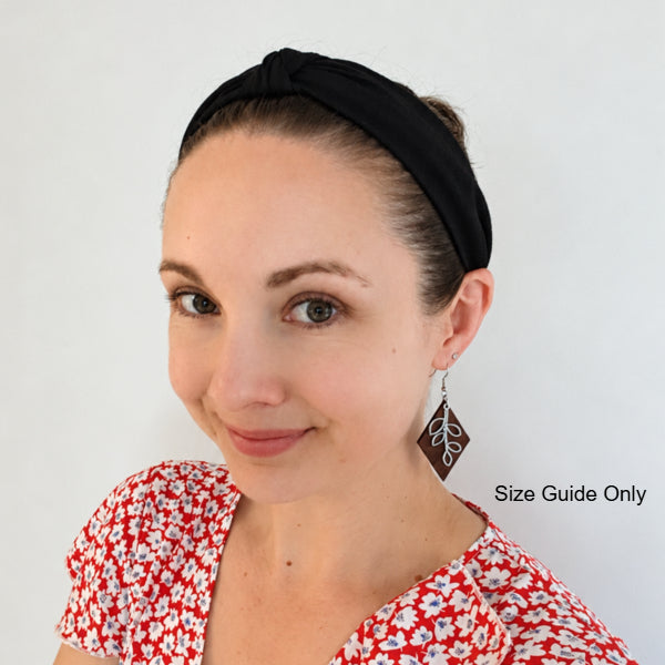 Woman wearing Rowan drops as a size guide.