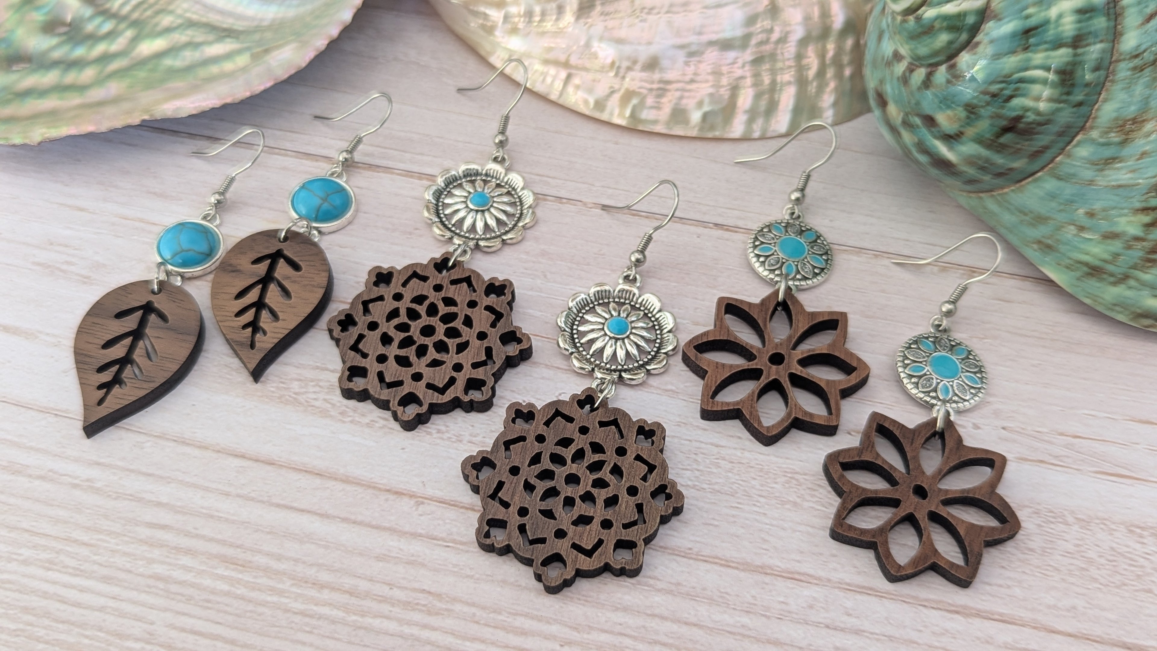 Wooden earrings with turquoise stones on a wooden surface