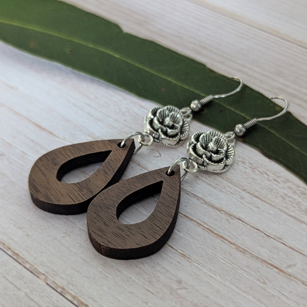 wooden tear drop earrings with silver toned flower connectors. Stainless steel hooks.