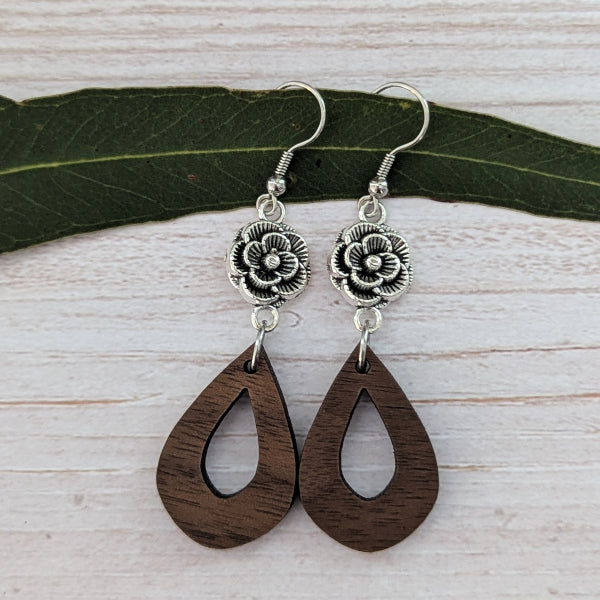 wooden tear drop earrings with silver toned flower connectors. Stainless steel hooks.