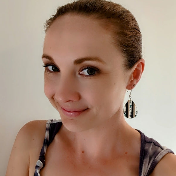 Women wearing stripes drops as a size guide.