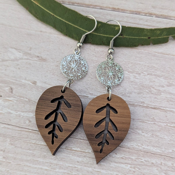 wooden leaf earrings with silver toned connectors and hooks.