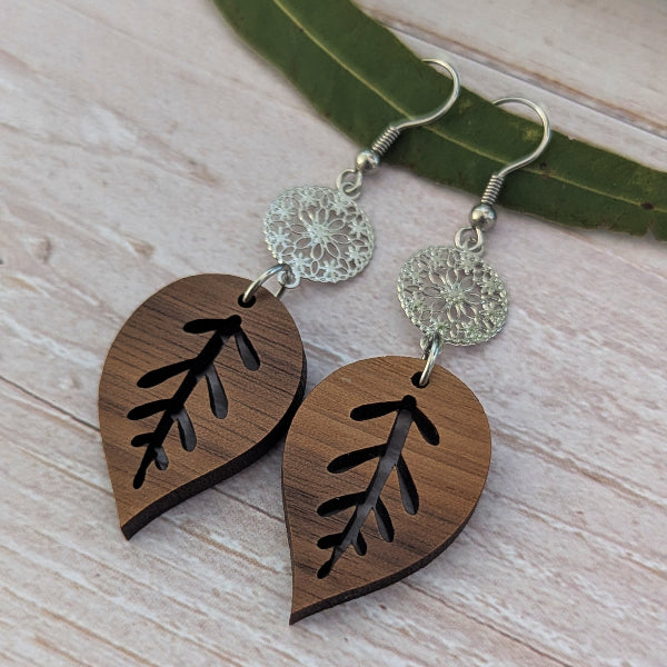 wooden leaf earrings with silver toned connectors and hooks.