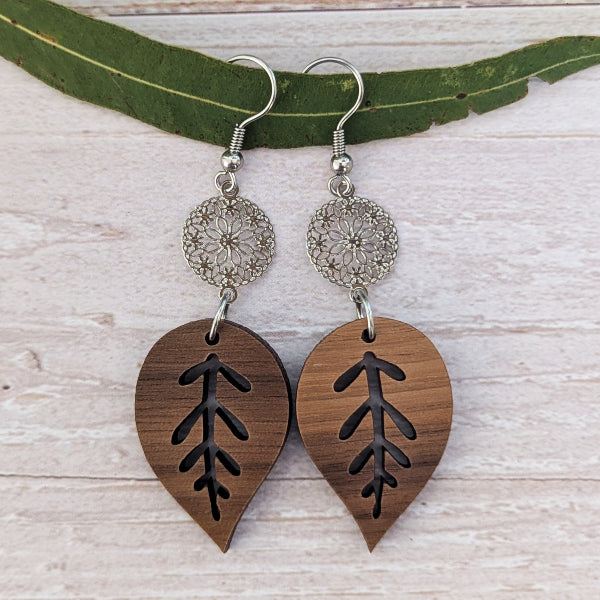 wooden leaf earrings with silver toned connectors and hooks.
