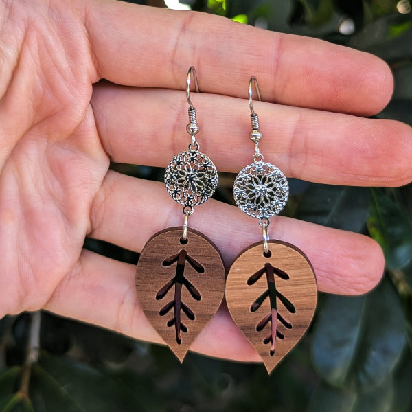 wooden leaf earrings with silver toned connectors and hooks.