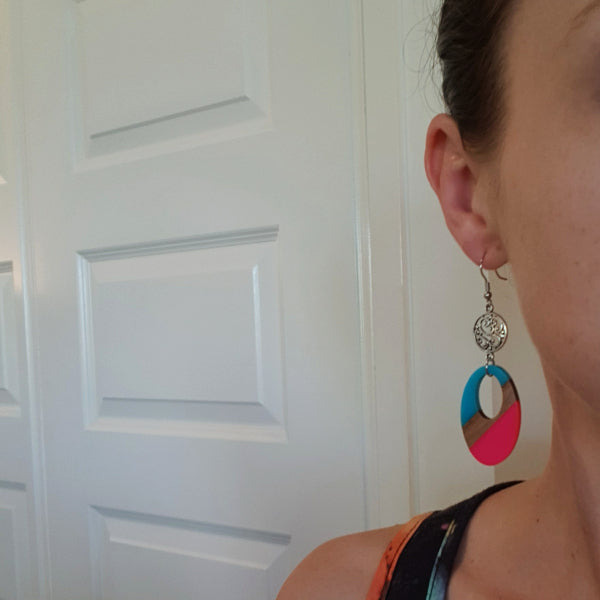 Women wearing oval dangles as a size guide.