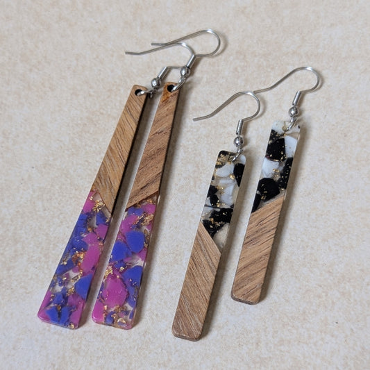 Two pairs of colourful earrings made from resin and wood on a beige background. Stainless steel hooks.