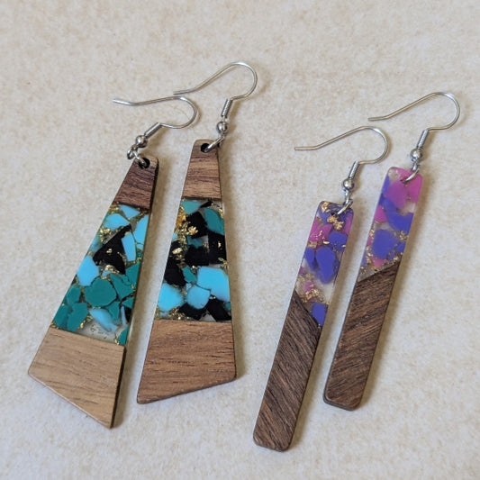 Two pairs of colourful earrings made from resin and wood on a beige background. Stainless steel hooks.