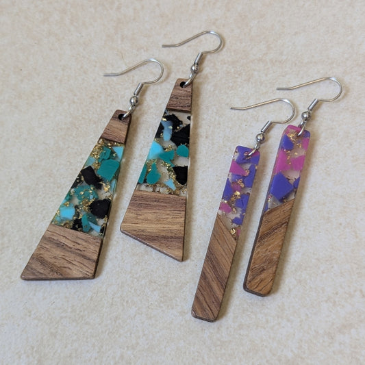 Two pairs of colourful earrings made from resin and wood on a beige background. Stainless steel hooks.