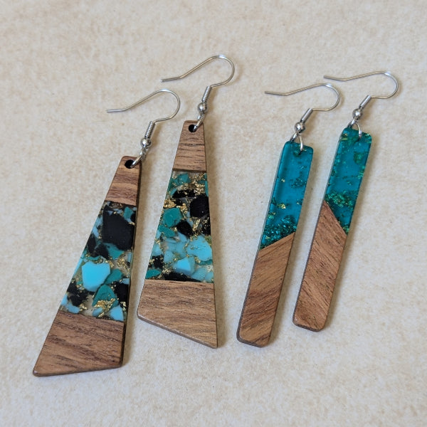 Two pairs of colourful earrings made from resin and wood on a beige background. Stainless steel hooks.