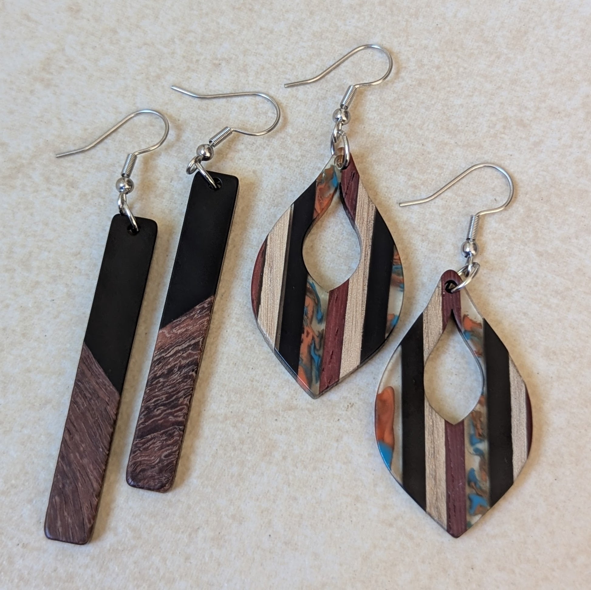 Two packs of wooden and resin earrings.