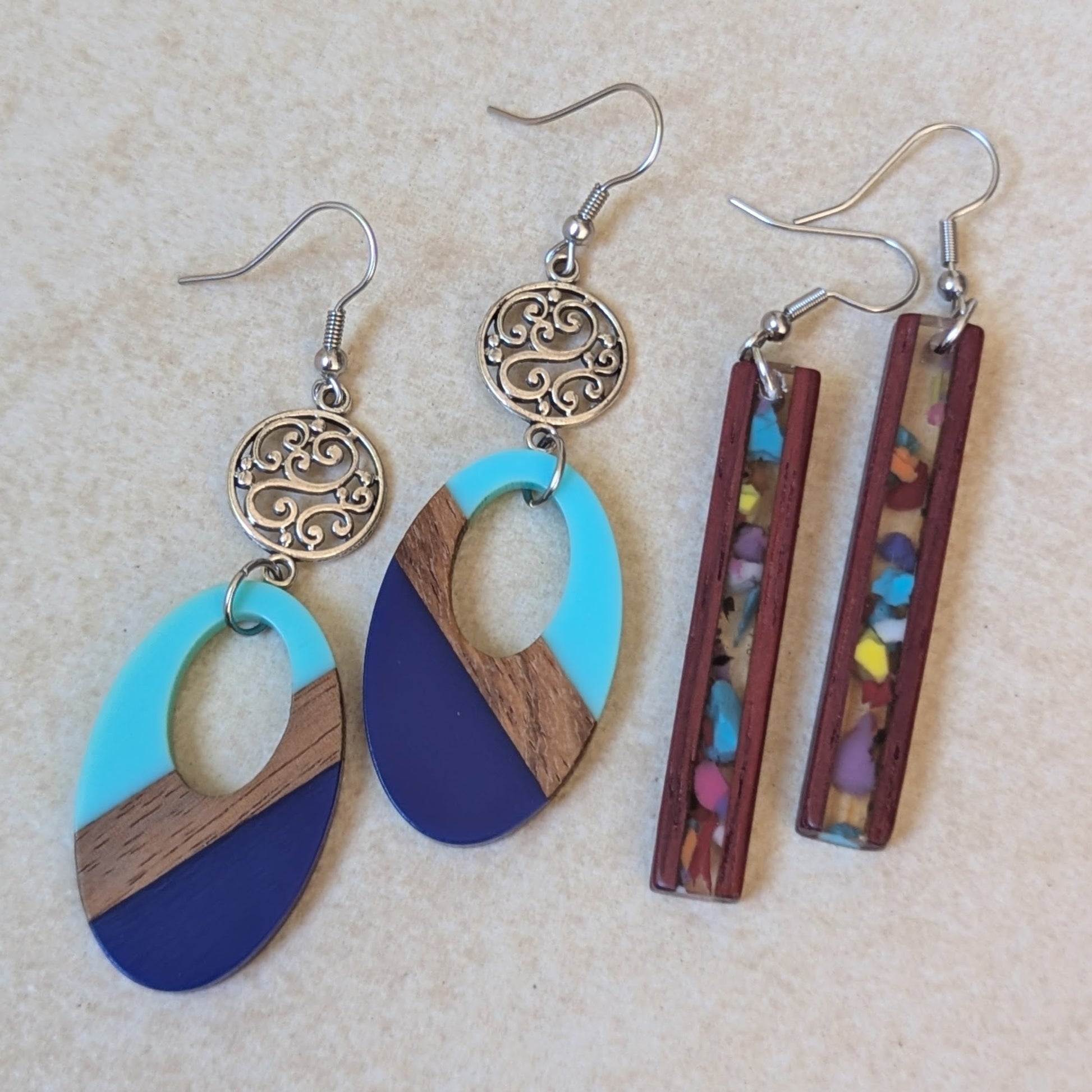 Two pairs of resin and wooden earrings.