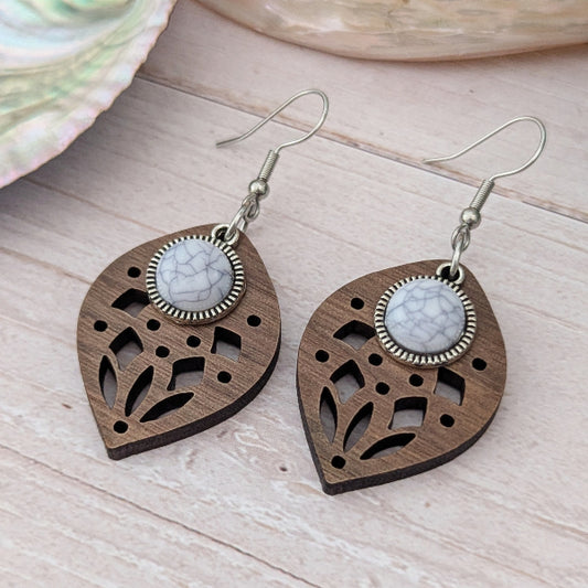 Wooden earrings with white stone centres on a wooden surface. Stainless steel hooks.