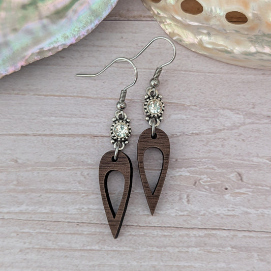 Wooden earrings with crystal connectors, light wood background. Stainless steel hooks.